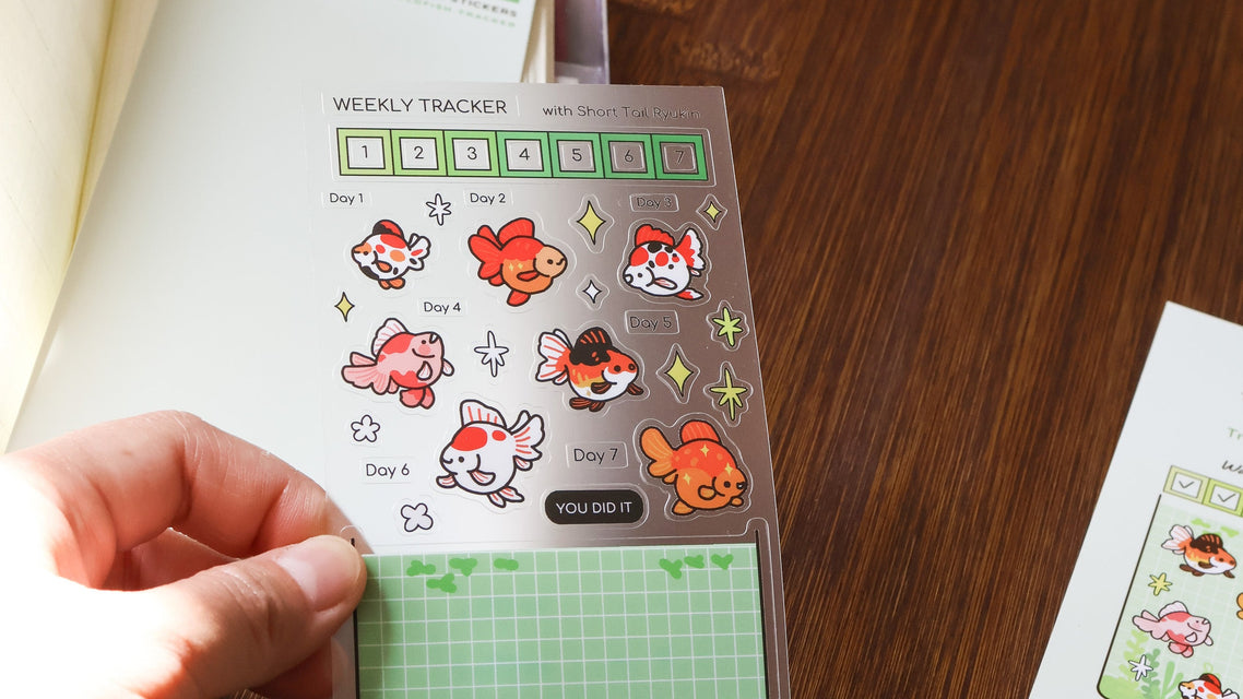 Weekly tracker with cartoon designs on a wooden surface